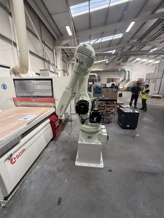 Fox Precision Tooling six-axis robot arm with EOAT mounted, workshop floor