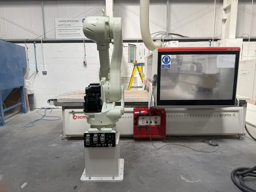 Fox Precision Tooling six-axis robot with control cabinet and HMI in the workshop