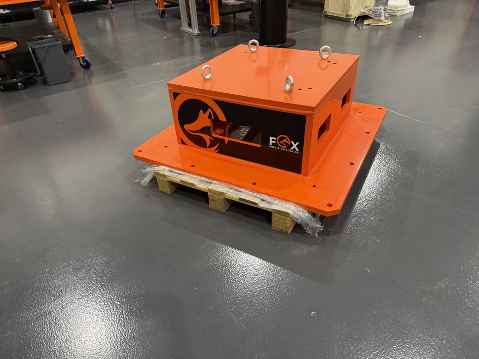Fox Precision Tooling orange control enclosure, palletised and ready for shipping