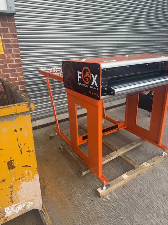 Fox Precision Tooling standalone orange conveyor unit outside the workshop