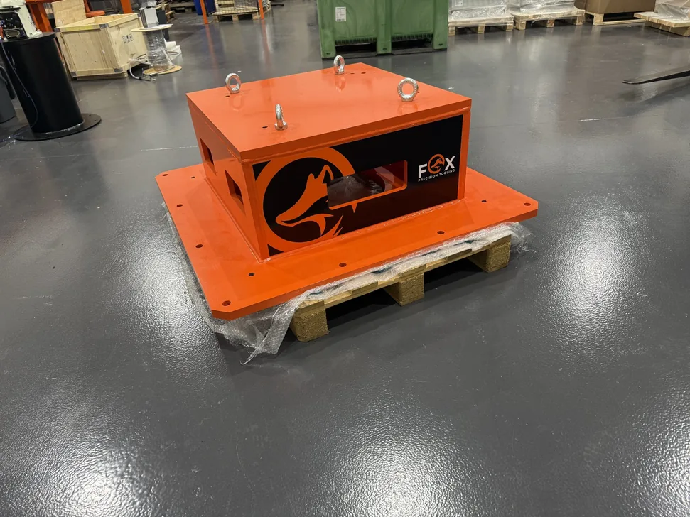 Fox Precision Tooling orange control enclosure, palletised and ready for shipping