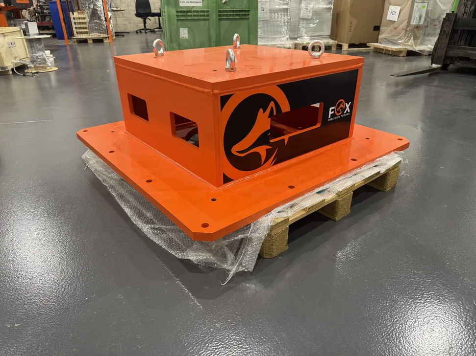 Fox Precision Tooling orange control enclosures, palletised and ready for shipping