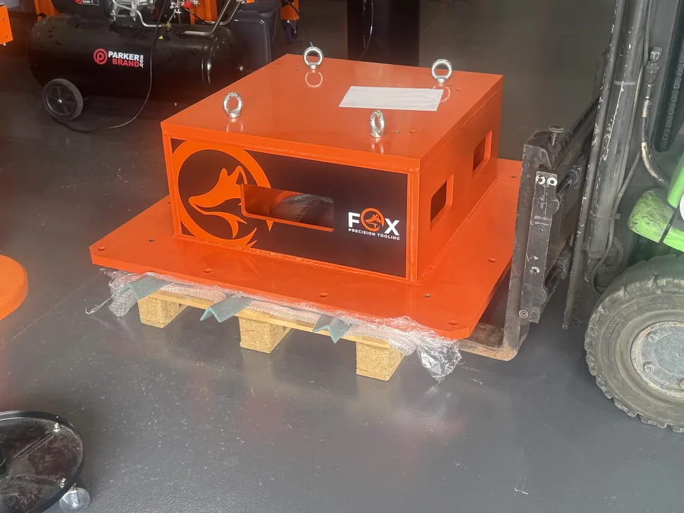 Fox Precision Tooling orange control enclosure, palletised and ready for shipping