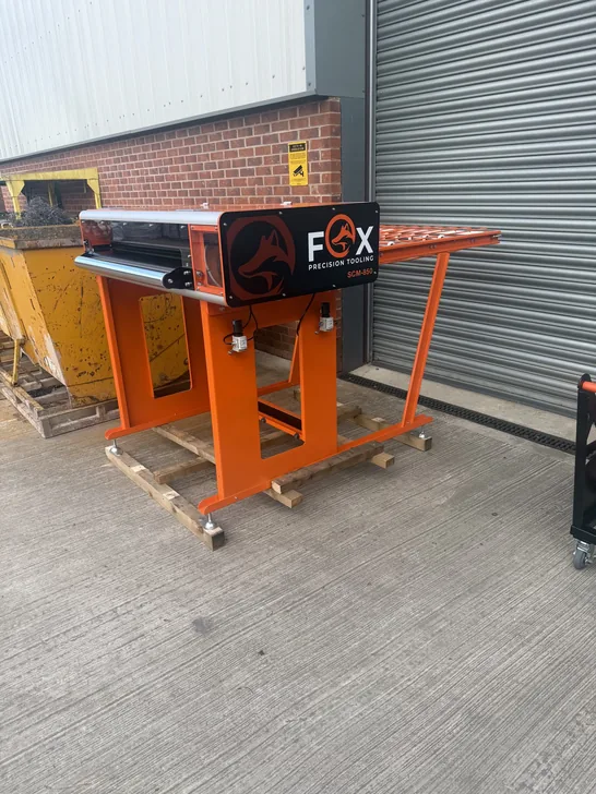 Fox Precision Tooling standalone orange conveyor unit outside the workshop