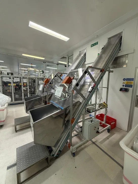 Fox Precision Tooling workshop floor with a stainless elevator conveyor system