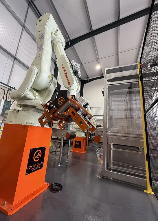 Fox Precision Tooling six-axis robot cell with EOAT attached, workshop floor