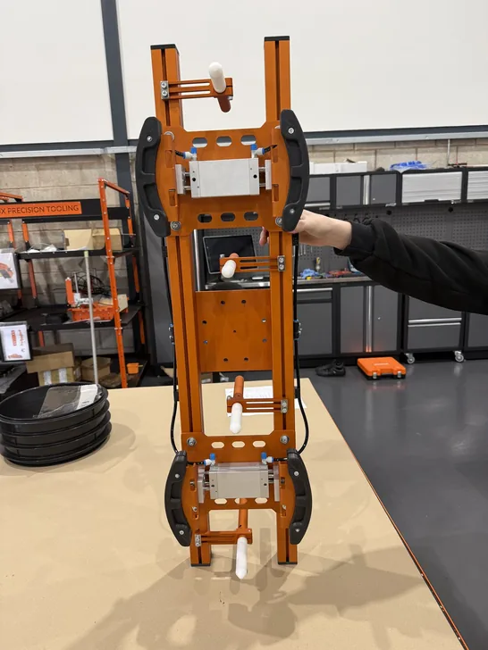 Fox Precision Tooling team member standing with a finished EOAT build