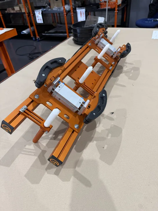 Fox Precision Tooling orange EOAT gripper tool on a test stand