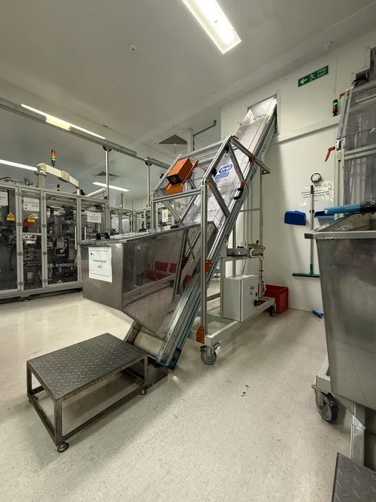 Fox Precision Tooling workshop floor with a stainless elevator conveyor