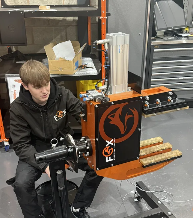 Fox Precision Tooling team member working on an EOAT-fitted conveyor stand