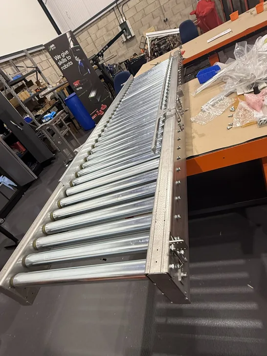 Fox Precision Tooling roller conveyor on a wheeled stand