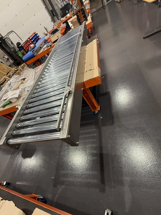 Fox Precision Tooling roller conveyor on a wheeled stand, workshop floor