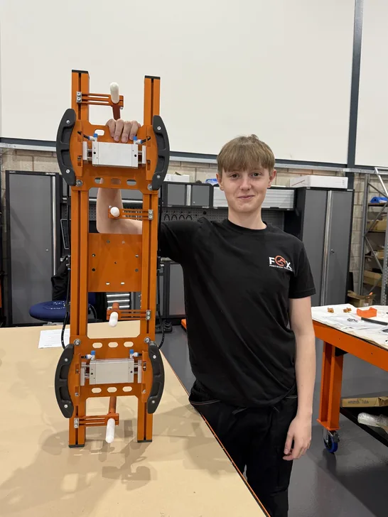 Fox Precision Tooling team member standing with a finished EOAT build