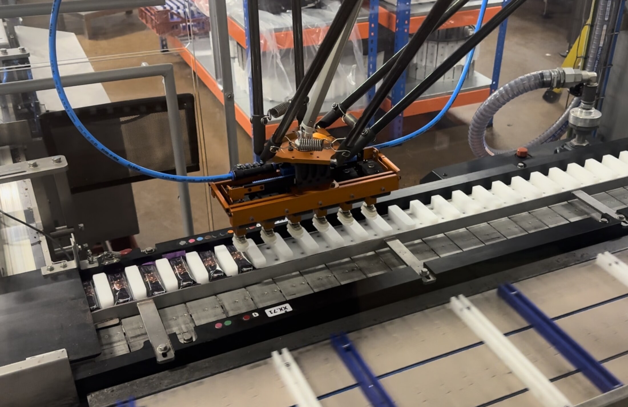 Fox Precision Tooling delta robot picking cell running on a production line