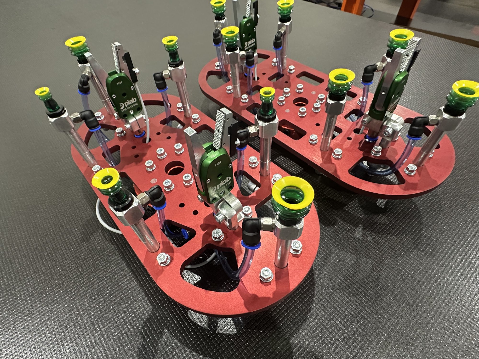 Two Fox Precision Tooling gantry end plates with vacuum cup grippers side by side