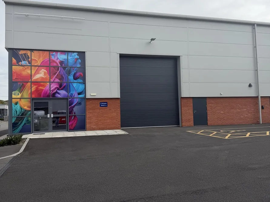 Front elevation of the new unit showing the loading bay roller shutter, personnel door and brick base